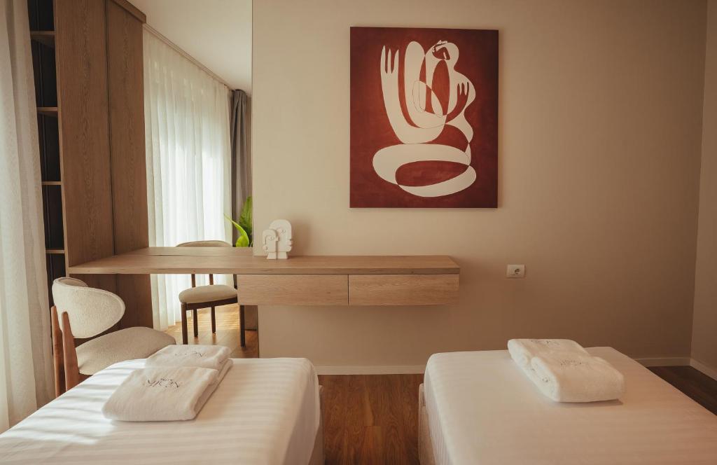 Twin beds beneath bold red statement artwork
