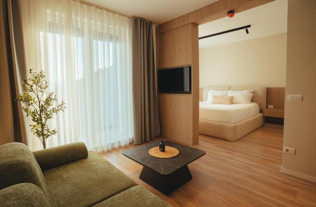 Open living area with sofa, TV and bedroom beyond